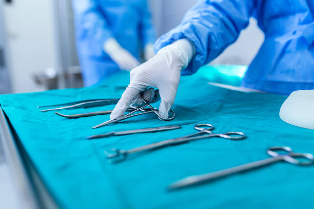 Nurse hand taking surgical instrument