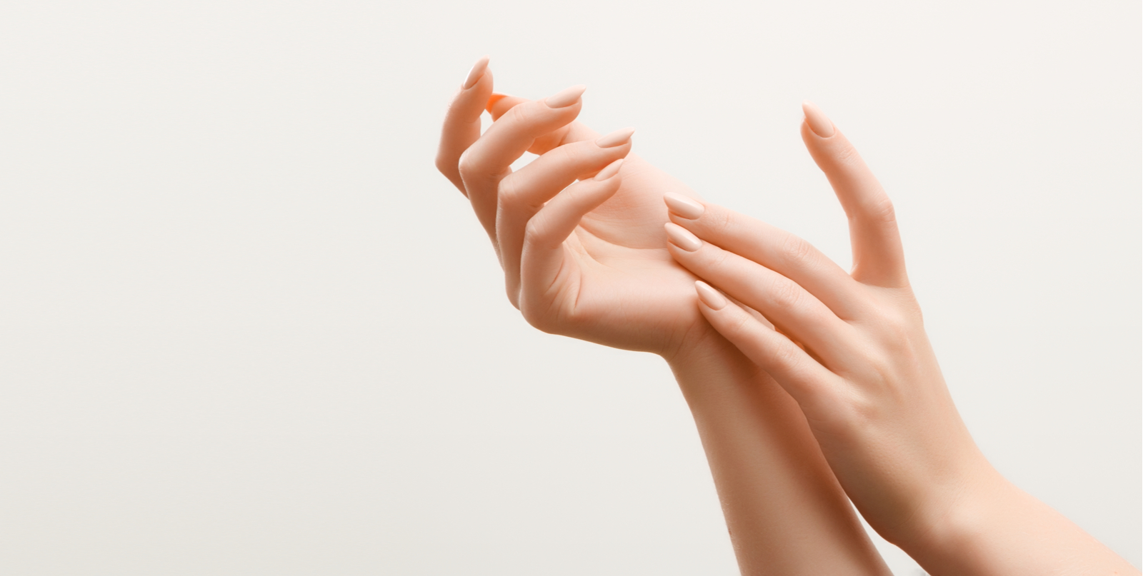 Female Hands Applying Cream